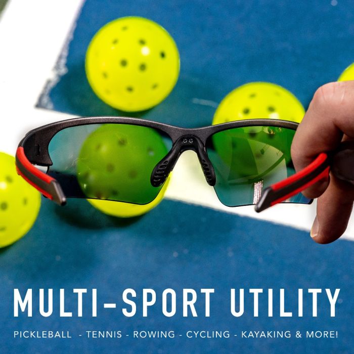 Sport sunglasses with red accents, shown against pickleballs on a court.