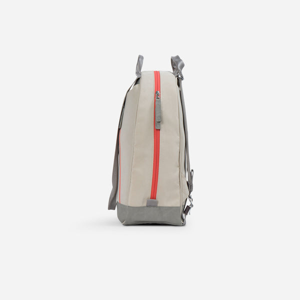 Beige pickleball backpack with gray accents and coral zipper detail, shown from the side against a white background.