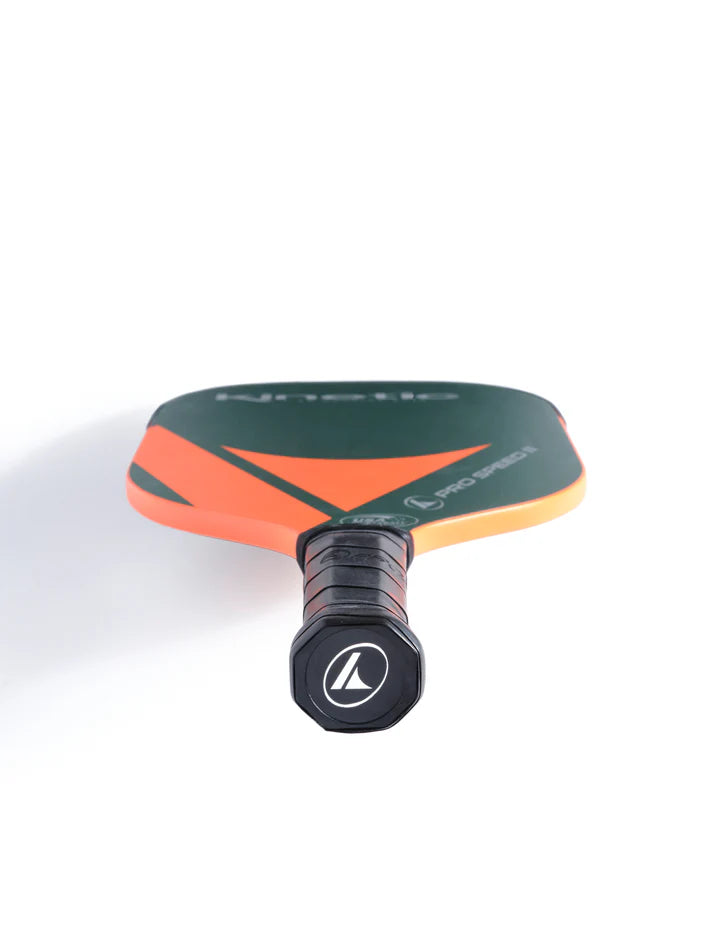 Pickleball paddle with orange and dark green face, black grip, close-up view.
