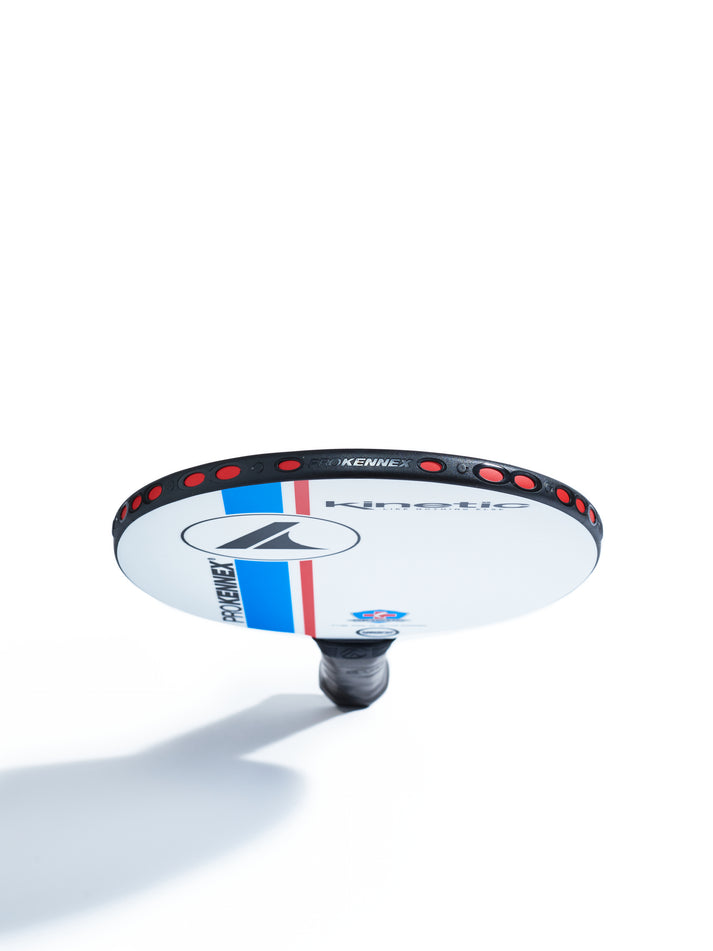 White and black pickleball paddle with red accents, viewed from below against a white background.