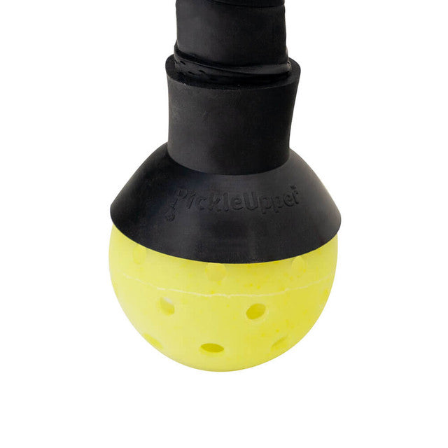 Yellow pickleball ball retriever attached to paddle handle.