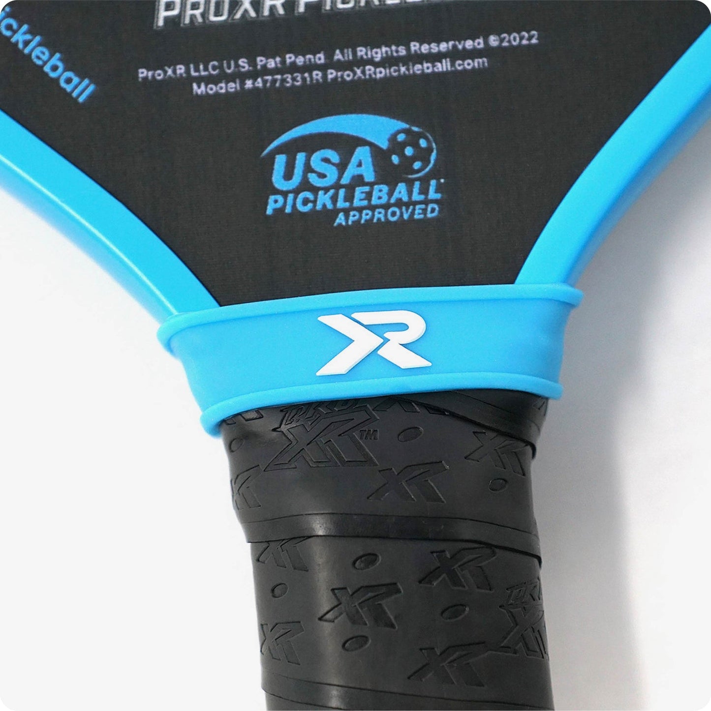 Close-up of a pickleball paddle's grip and handle, showcasing a blue and black design with USA Pickleball Approved logo.