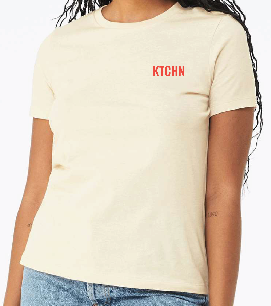 Cream-colored short-sleeve tee with small red logo; casual style.