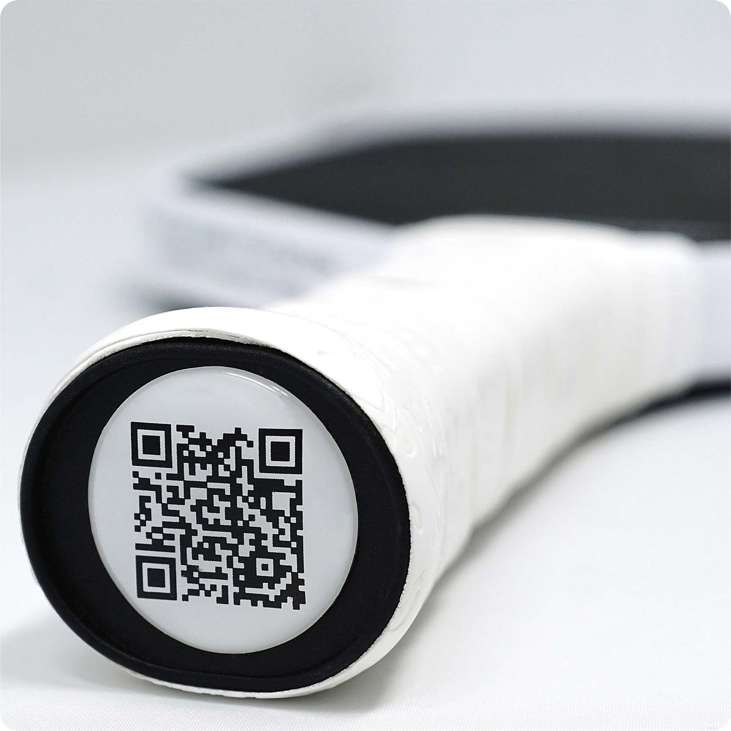 Close-up of a white paddle handle featuring a QR code.