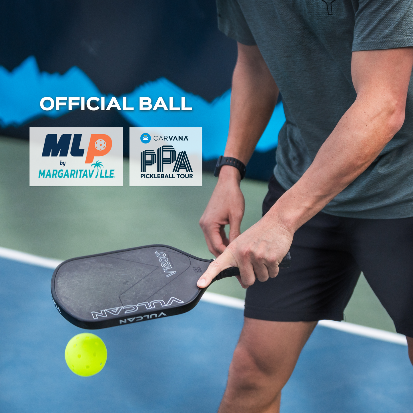 Pickleball player holding black paddle on outdoor court, yellow ball in the air.