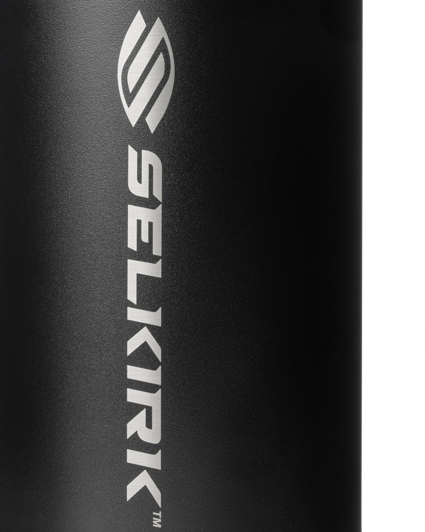 Close-up of a black water bottle's textured surface with a silver logo.