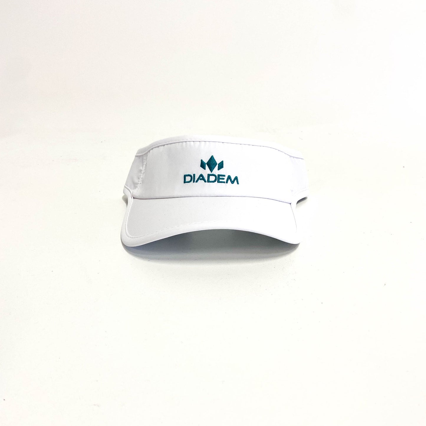 White visor with teal logo against a white background.