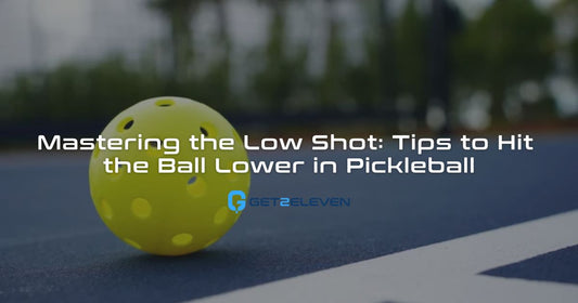 Yellow pickleball on a court near a white line.
