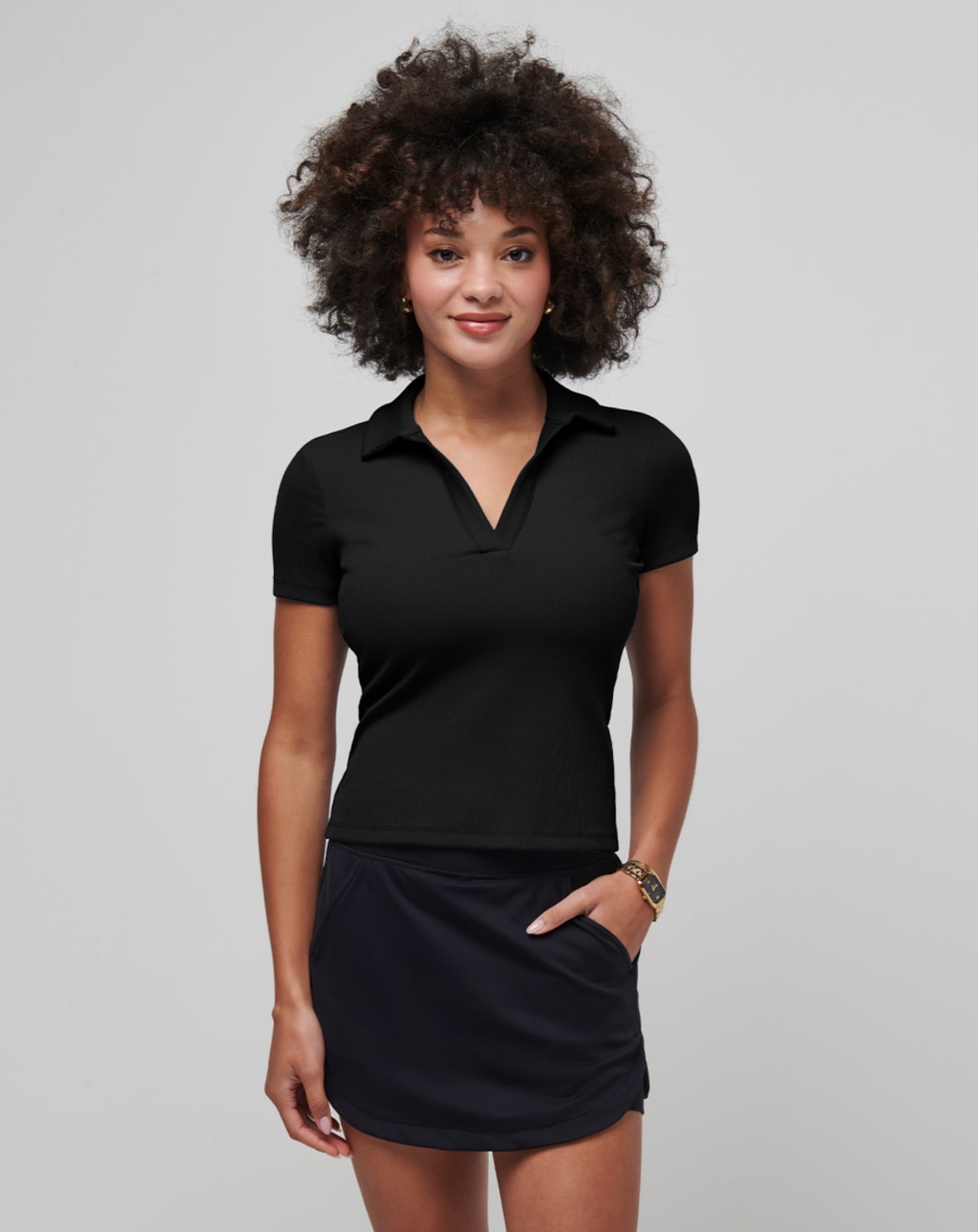 Travis Mathew Moveknit V-neck Polo: Black ribbed knit polo shirt, flattering fit.
