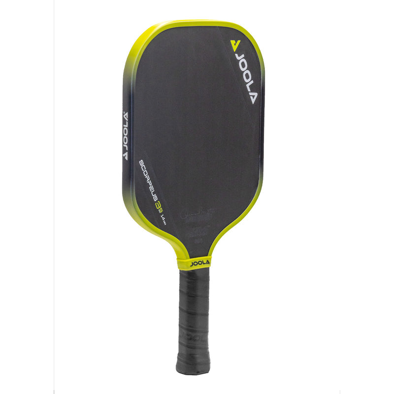 Pickleball paddle with graphite face, neon yellow accents, and a textured grip.
