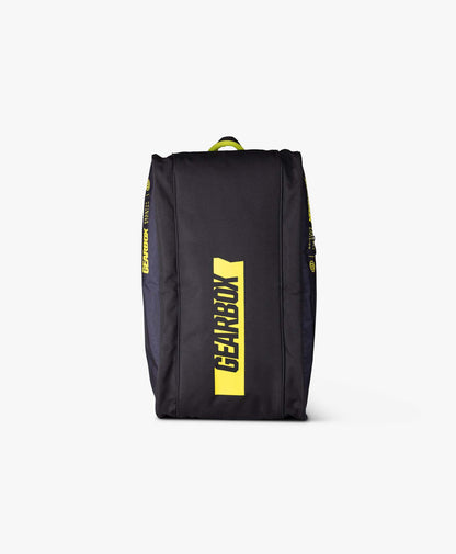 Black duffel bag with yellow logo, shown against a white background.
