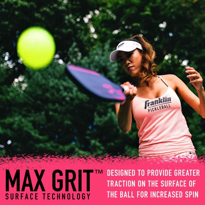 Woman playing pickleball outdoors, striking a ball with a fiberglass paddle featuring Max Grit surface technology for enhanced spin.
