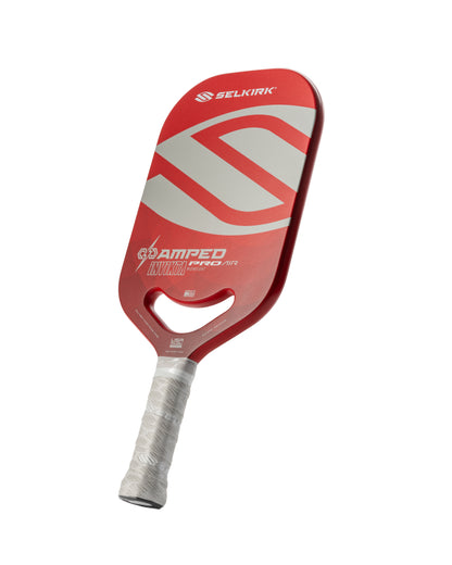 Red pickleball paddle with gray accents, showcasing a lightweight design and comfortable grip.
