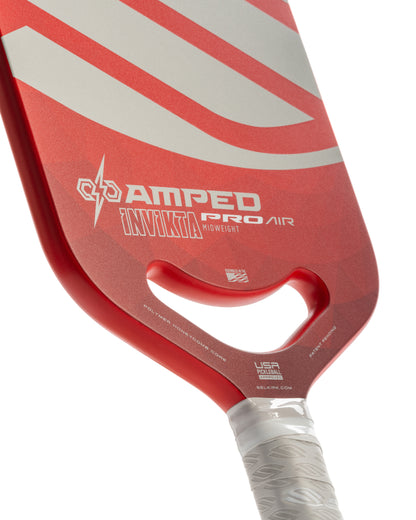 Red pickleball paddle close-up showcasing polymer honeycomb core; USA Pickleball Approved.
