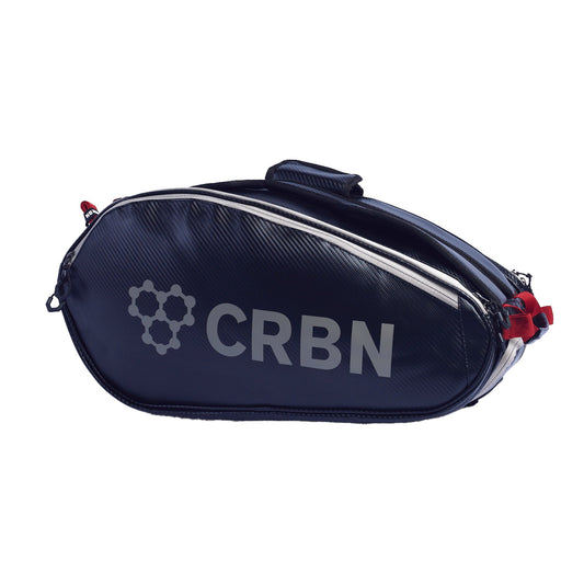 Dark blue sports bag with a carbon fiber texture, featuring red accents and a zipper closure.
