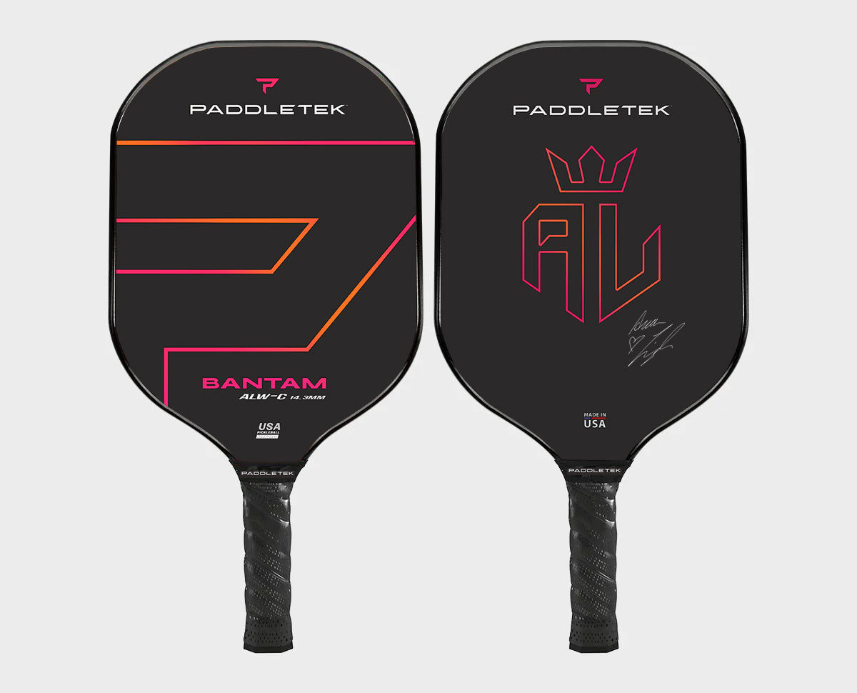 Pair of black pickleball paddles; one features pink & orange graphic lines, the other a monogram.
