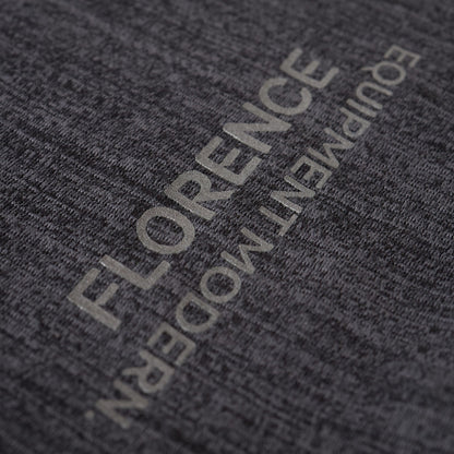 Close-up of dark gray long-sleeve shirt's fabric texture, showcasing subtle silver lettering.
