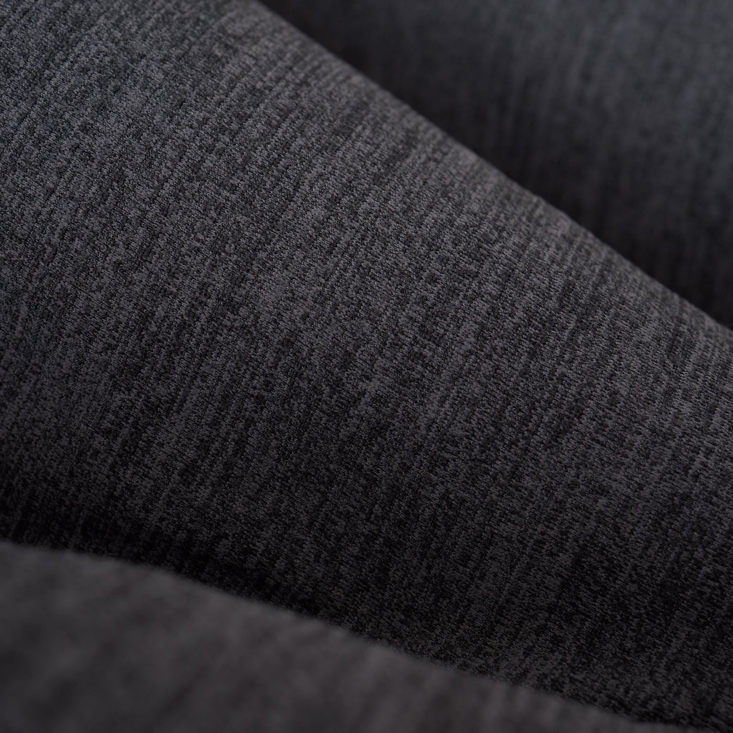 Close-up of charcoal gray heathered long-sleeve shirt fabric.
