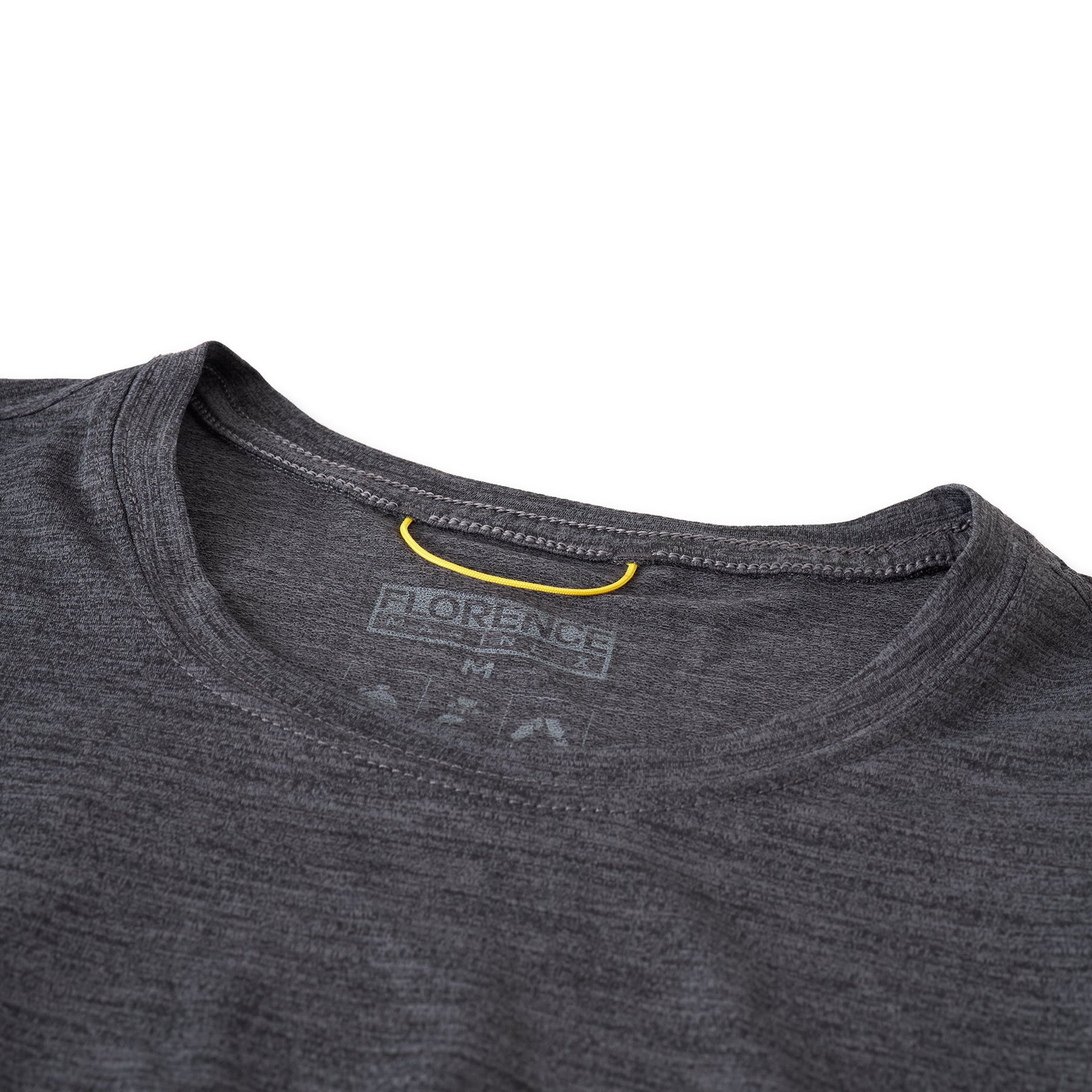 Close-up of a charcoal gray long-sleeve shirt's neckline and size tag.
