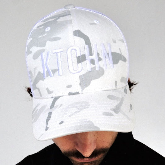 KTCHN Camo Trucker Hat: White camo print,  mesh back,  embroidered logo.
