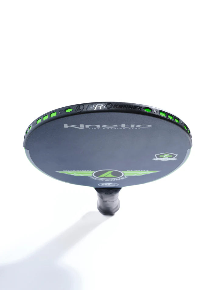 Black pickleball paddle viewed from above, showcasing green accents and "Kinetic" branding.
