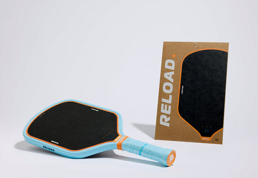 Reload RLD 1-16mm Pickleball Paddle: light blue with orange accents, includes 2 extra grip sheets.
