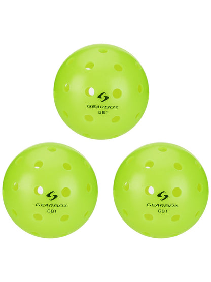 Three lime green pickleballs with holes, ready for a game.
