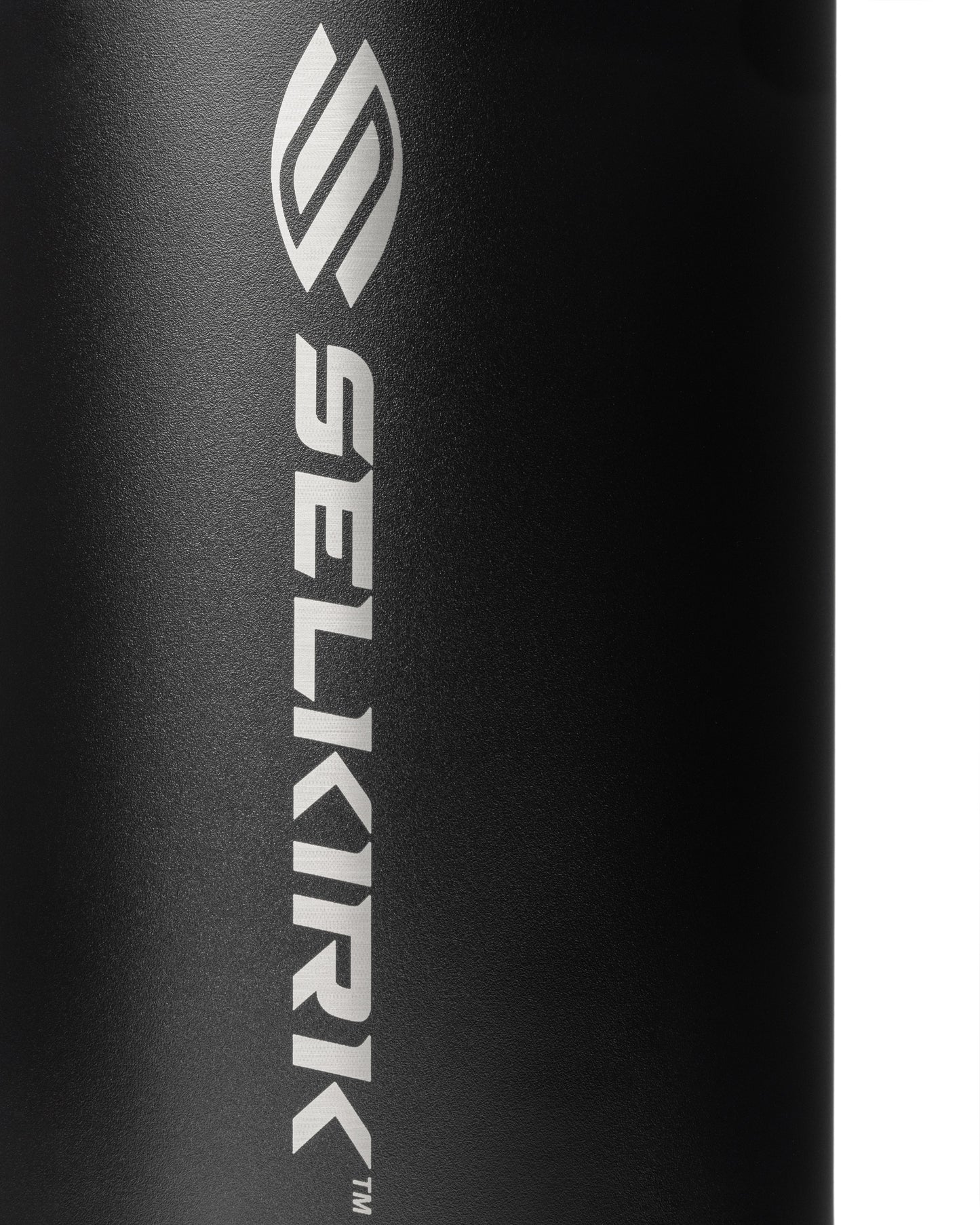 Close-up of a black water bottle's textured surface with a silver logo.
