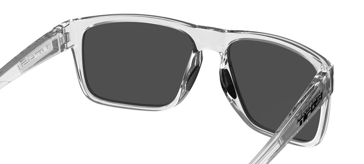 Clear frame sunglasses with smoke-grey lenses; close-up view.
